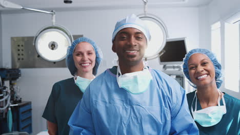 portrait of multi-cultural surgical team standing in hospital operating theater