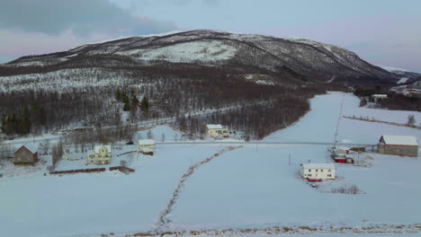 car drives through snow covered village, polar night