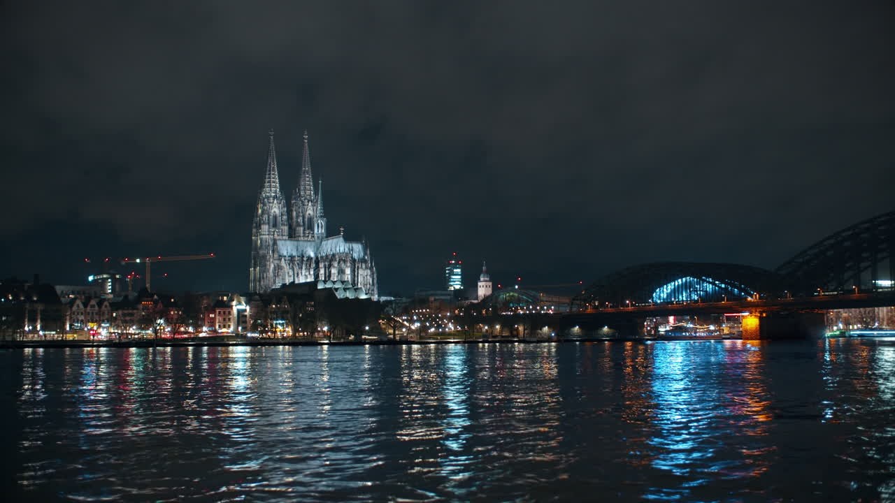 Cologne Cathedral panoramic Shot at night with nice lights, high water and a settle Time-lapse only in the Sky