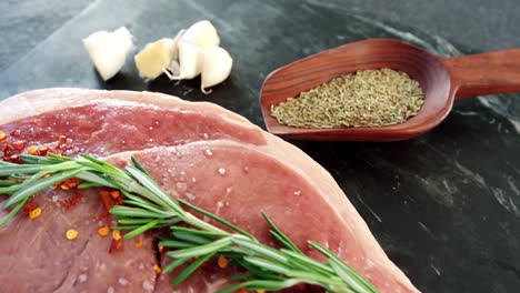 raw sirloin chop, garlic, rosemary, and spice