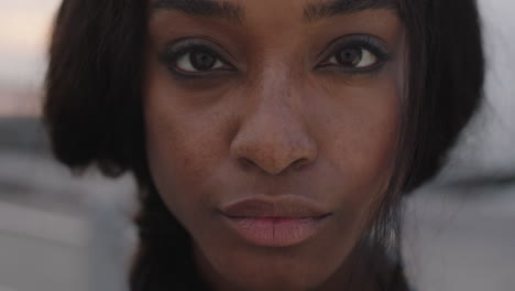 close up portrait of beautiful african american woman looking focused to camera intense