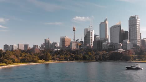 fancy yacht anchored in sydney bay in front of botanic garden and cbd aerial