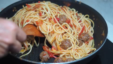 preparing spaghetti with meatballs