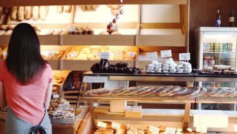 Female-baker-holding-croissants-in-basket