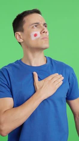Man listening to the Japan national anthem with solemnity