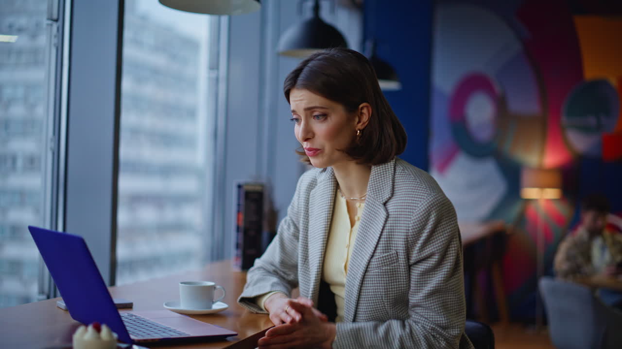 Online manager speaking virtual meeting cafeteria portrait. Woman video calling