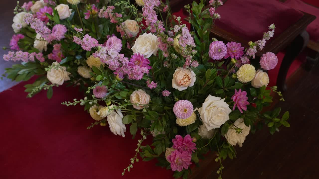 결혼 제단 위의 장미와 녹색 식물이 있는 로맨틱한 꽃다발