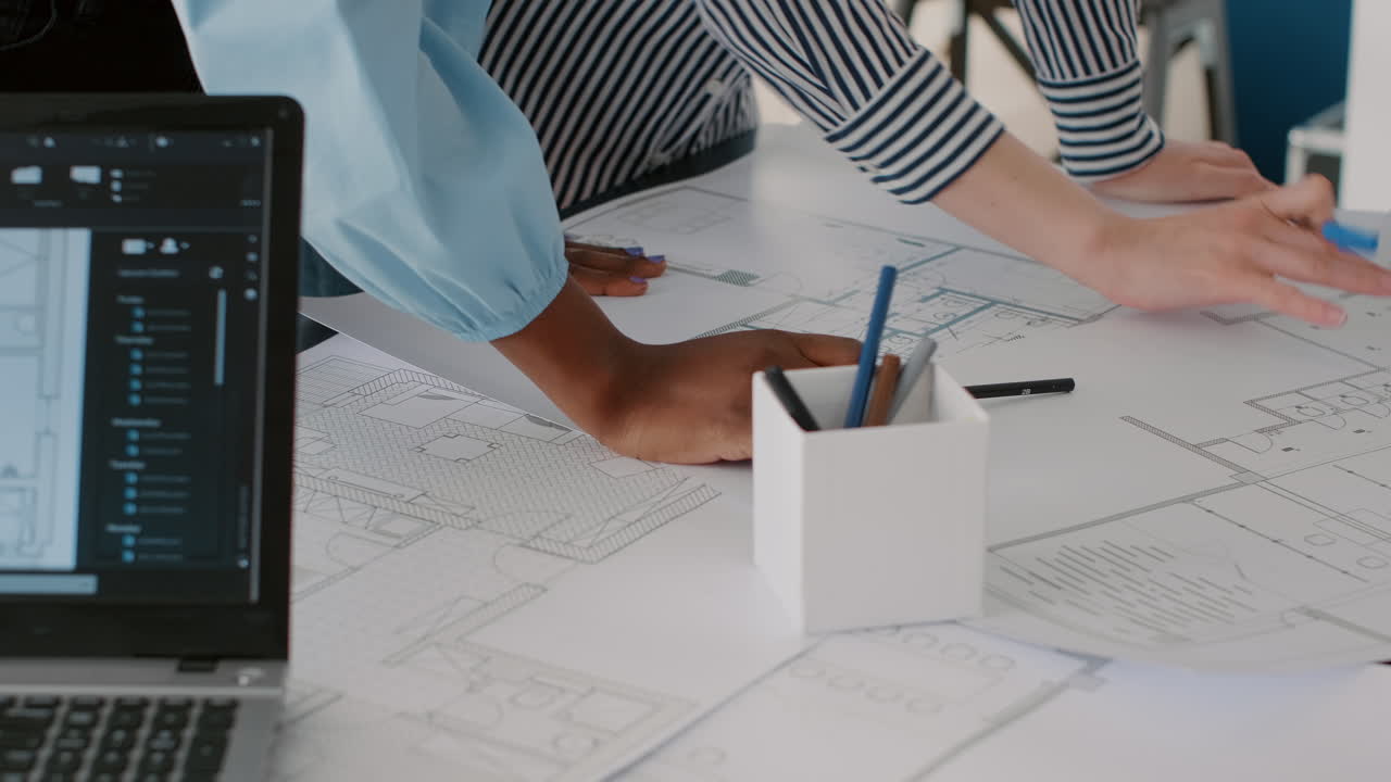 Architects collaborating on blueprint design