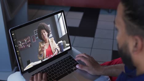 African-american-businessman-using-laptop-having-video-call-with-female-colleague