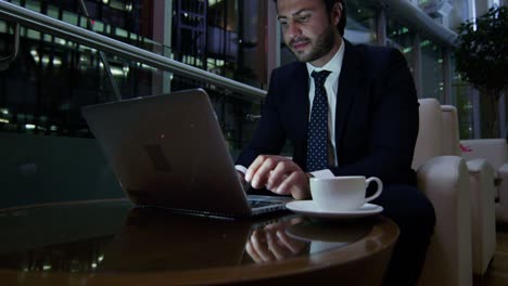 arabic male business traveller laptop night hotel atrium