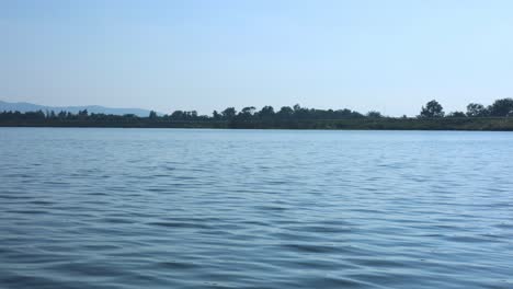 calm water surface with distant landscape view