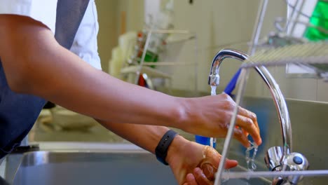 Chef-washing-hands-in-sink-in-kitchen-4k