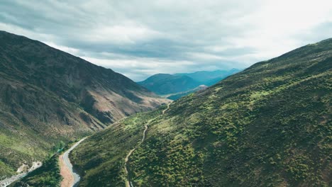 Drone-flying-over-river-between-two-mountian-ranges