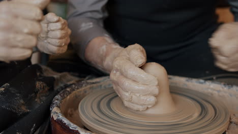pottery class: hands shaping clay on a pottery wheel