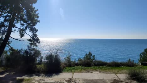 train ride along sea shore, view from window at empty coast at summer in sunlight