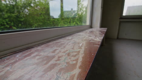 Shot-of-a-stone-windowsill-in-an-empty-house