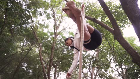 A-sporty-gymnast-performs-exercises-with-a-rope-in-sportswear