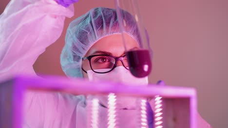 researcher studying colorful liquid solution reactions on laboratory during analysis for coronavirus outbreak