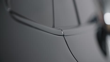 close-up of a black car's body panel