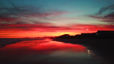 Crazy-establishing-aerial-shoot-of-ocean-and-beach-in-unbelievable-burning-sunset