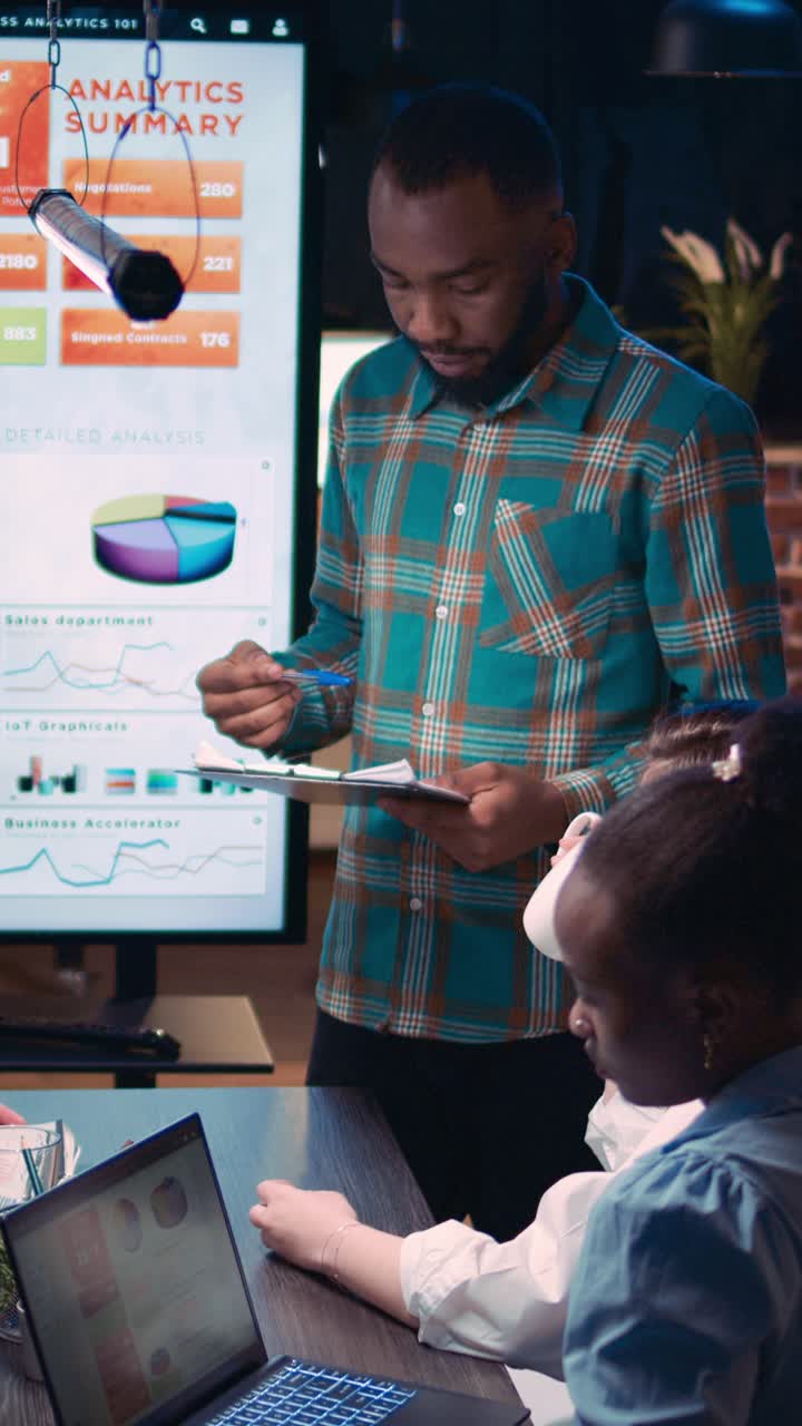 Vertical video: African american man giving financial report presentation