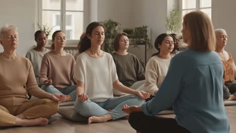 a group of people meditating in a yoga class
