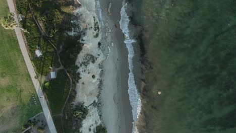 birdseye view of a public park on the shoreline of the pacific ocean during sunset