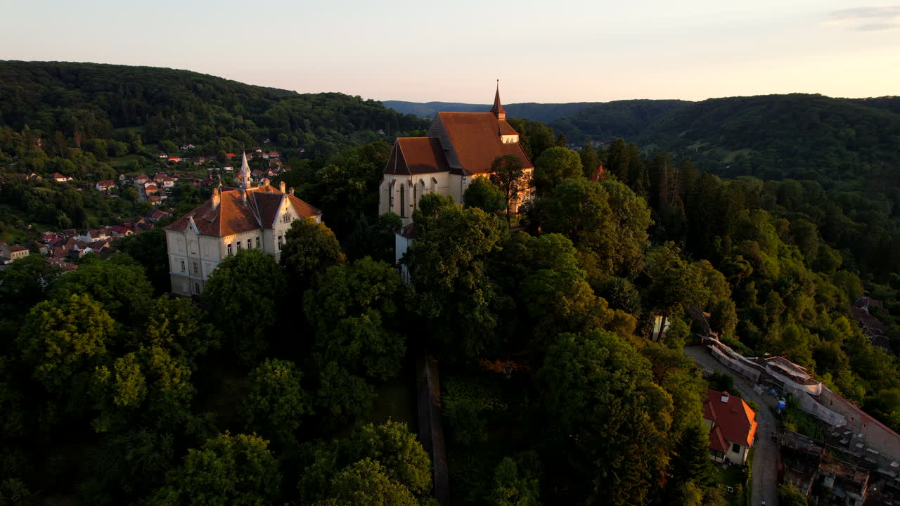 School hill of Sighisoara Romanian old city at sunset. Aerial view