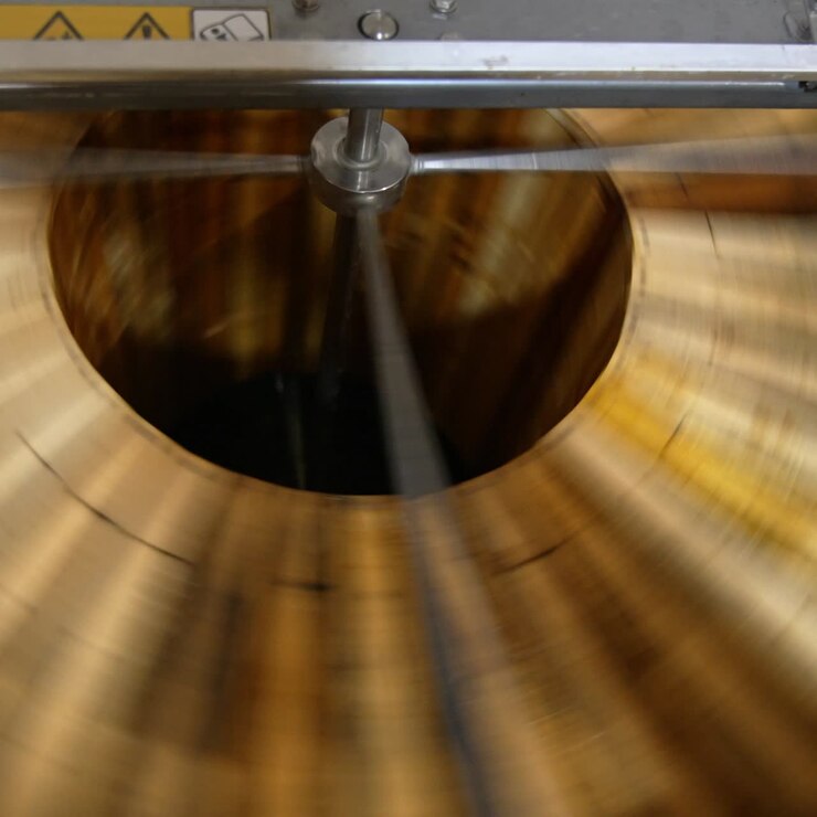 Quick spinning of honey frames in the automatic machine. Wooden honey frames are rotated to remove fresh organic honey from them