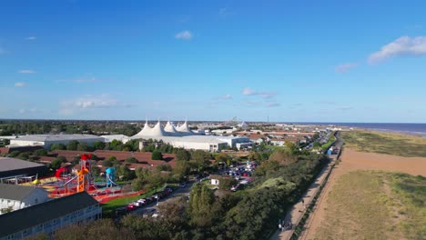 Aerial-drone-footage-of-the-famous-Butllins-holiday-camp-based-in-the-seaside-town-of-Skegness-Lancashire,-UK