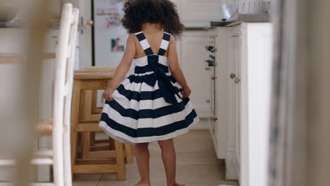 beautiful little girl dancing wearing pretty dress showing off cute dance having fun at home enjoying summer fashion