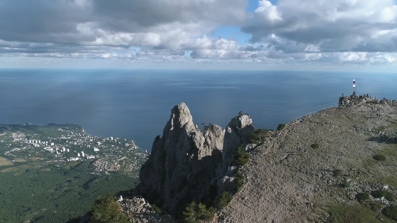 Aerial View of a Mountainous Coastline with a City and Ocean