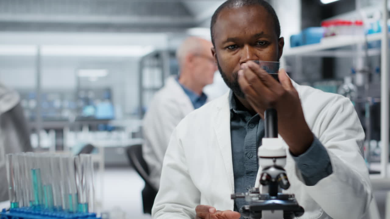 Pharmaceutical researcher analyzing bacterial culture slide