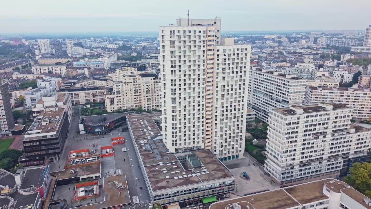 Drone moves above Rennes showing Colombier district, its tall tower, square, and surrounding buildings