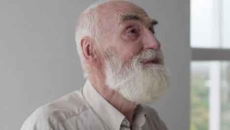 old gray haired man beginning his morning in pray, thanking god for new day