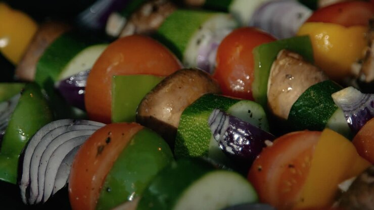 BBQ Vegetable Kebabs Being Brushed with Olive Oil as they Cook