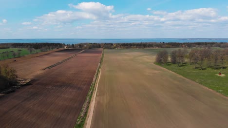 aerial of rural area clear field close to coast in oland island, sweden