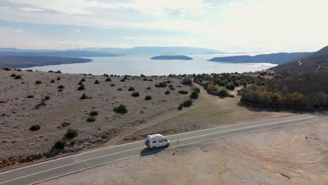 Follow-aerial-shot-of-camper-van-on-the-road