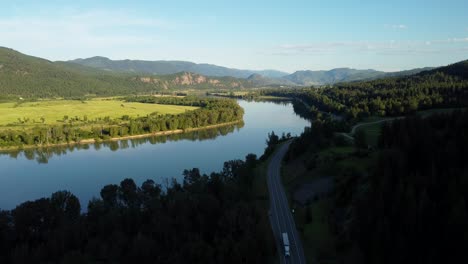 Wide-angle-aerial-view-river-and-farmland-in-nature-of-Canada-at-sunset