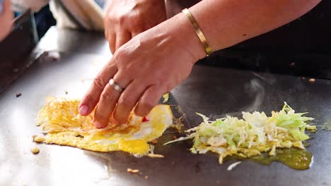 chef prepares a dish on a hot griddle