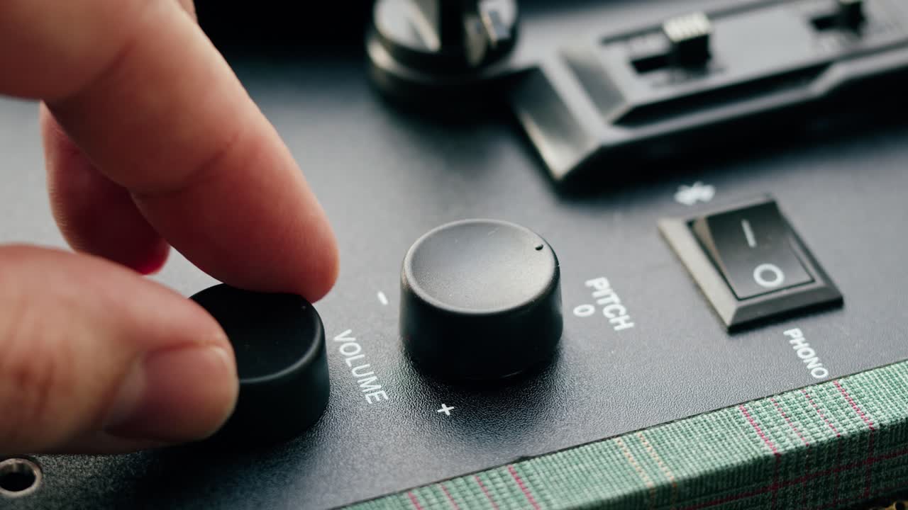 Close-Up of Hand Turning On/Off Knob on Turntable