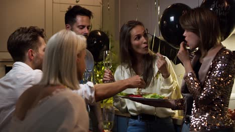 friends drinking and eating at the party