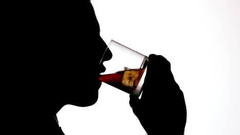 silhouette of businessman drinking whiskey on white background