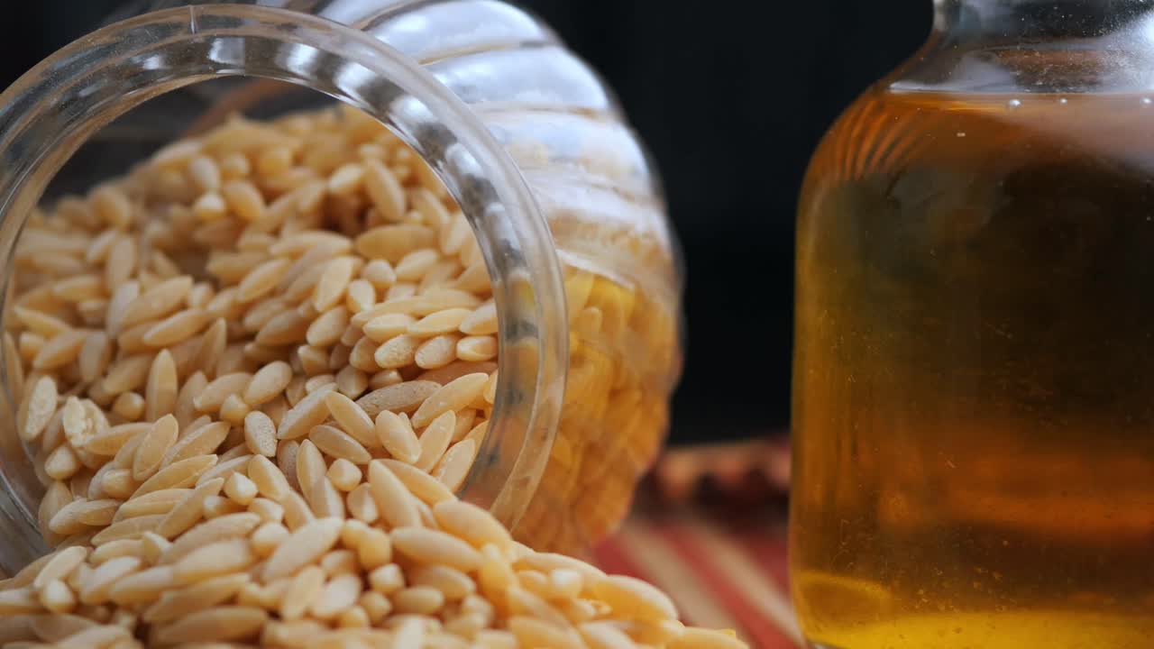 Orzo pasta in a glass jar with olive oil