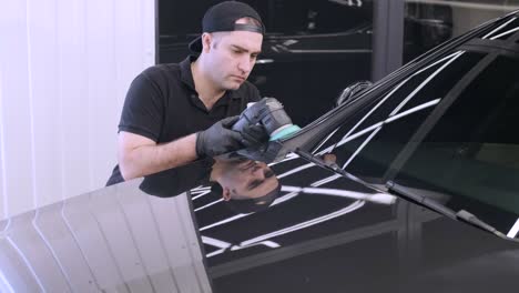 professional car detailing using machinery and polishers for paint restoration.