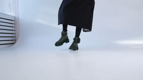 woman in olive green boots and black skirt