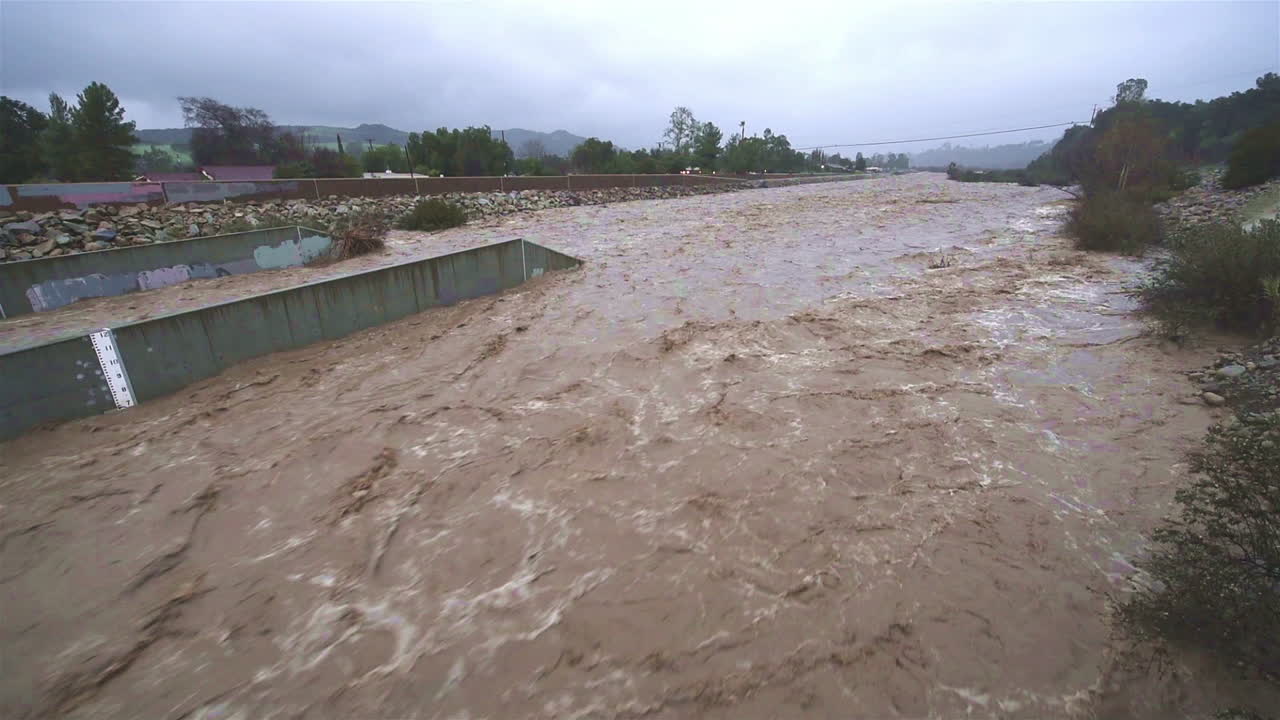 A river in Southern California begins to flood during a large storm