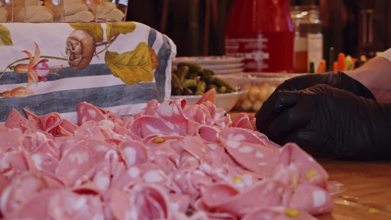 Chef decorates table with Parma ham meat servings at night