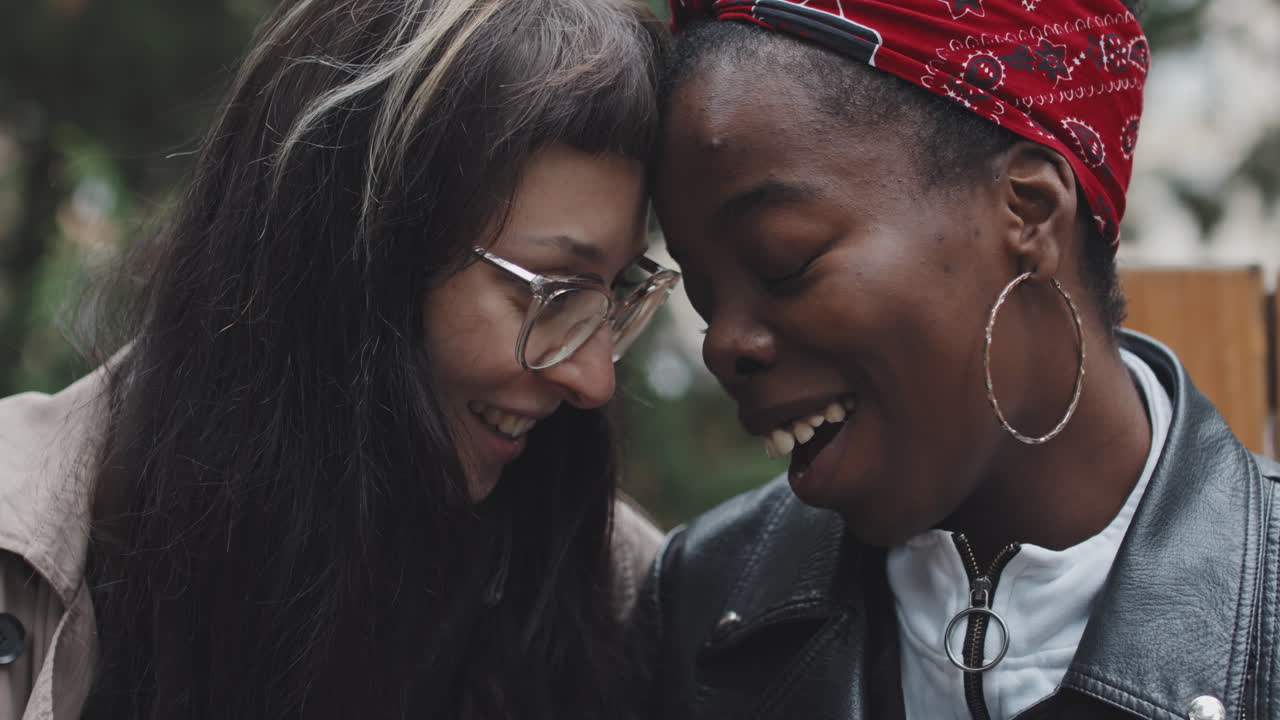 Female Couple Touching Foreheads and Laughing