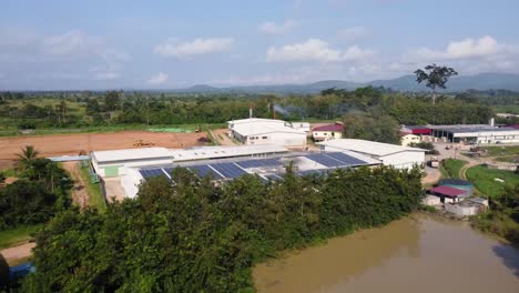 flying towards industrial buildings in the african countryside